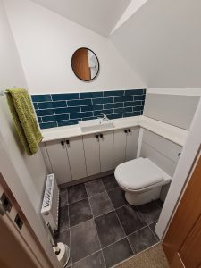 Small toilet under the stairs off the twin bedroom