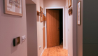 The front door opens to the open plan living area and the corridor to the bedroom and shower room