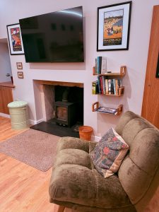 A comfortable chairby the wood burning stove in the lounge area